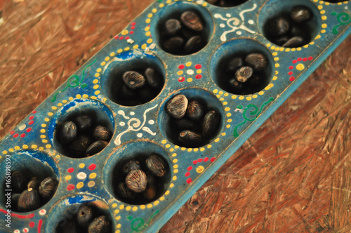 congkak or congklak, Traditional game with lots of holes and using seeds photo