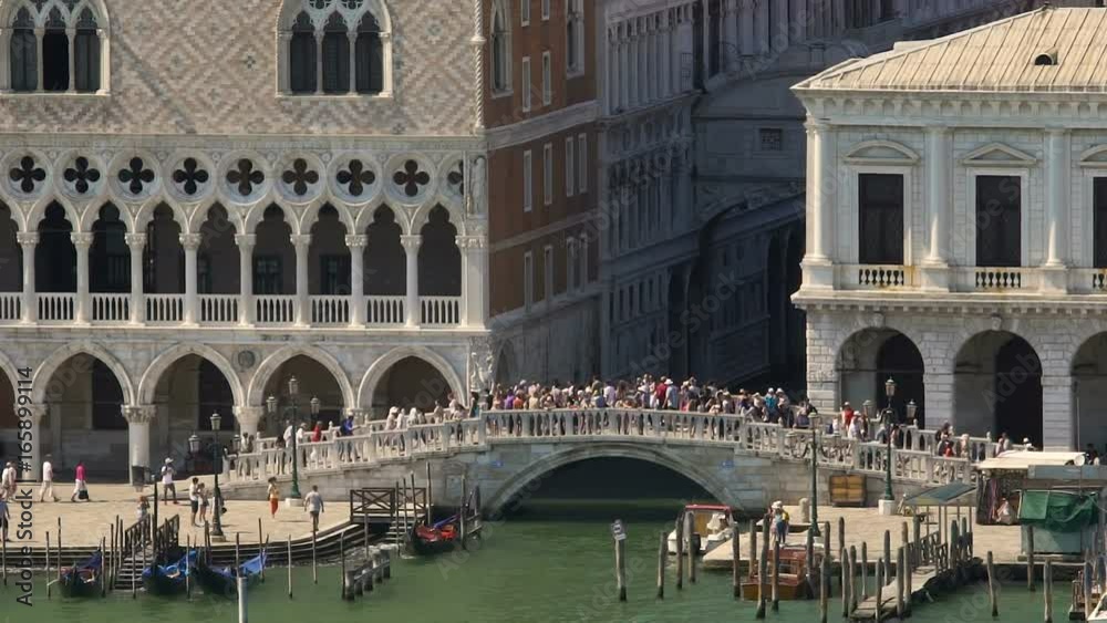 Crowded bridge across narrow channel in historical part, boats heaving on waves Crowded bridge across narrow channel in historical part, boats heaving on waves