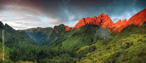 Canvas Print Amazing sunset and red afterglow in high mountains.