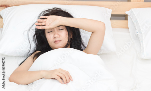 beautiful Asian women sick with sleep on bed