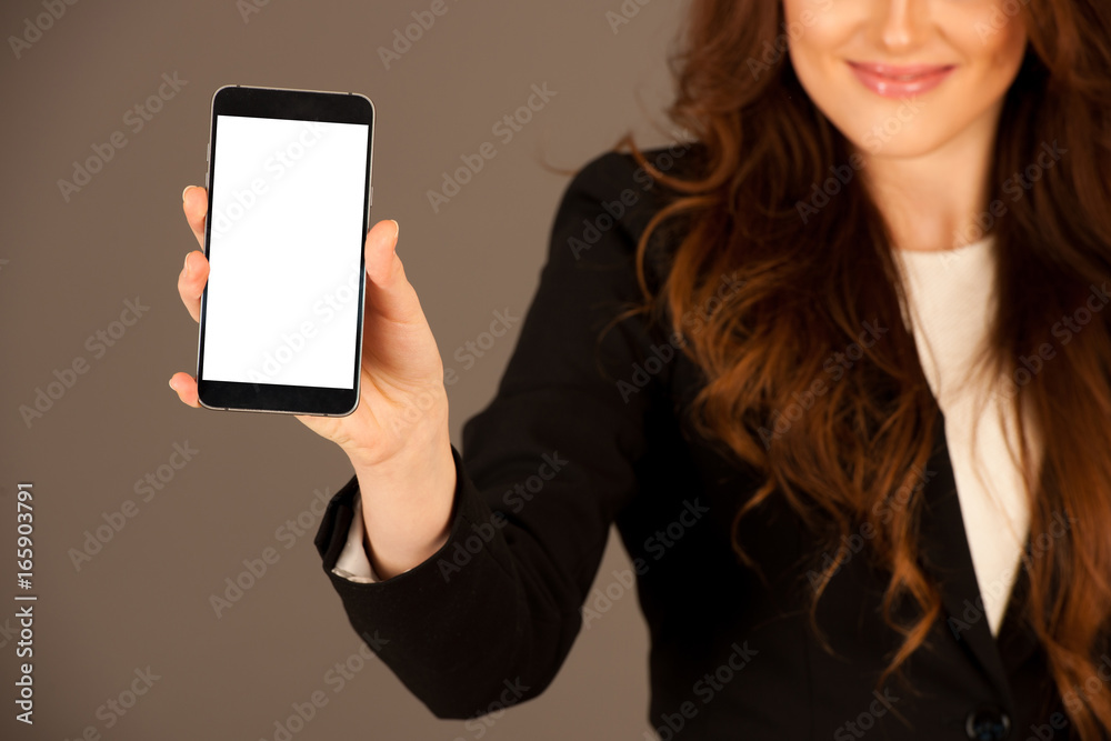 attractive business woman holds a tablet or smartphone wtih blank copy space for additional graphic or text