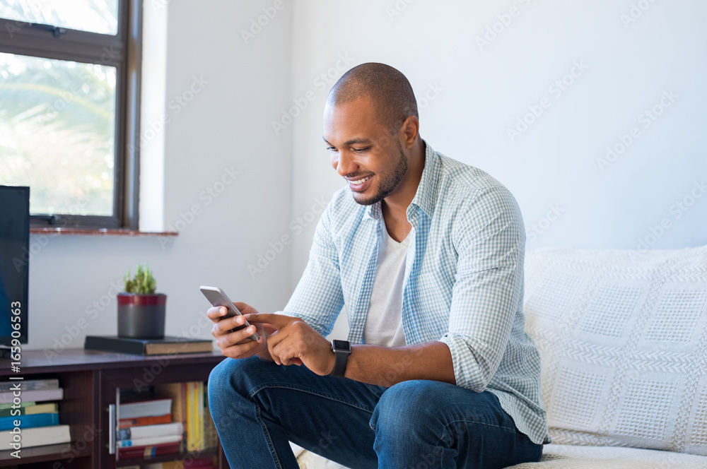 African man typing phone message African man typing phone message