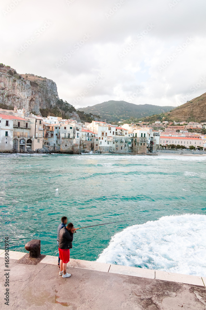 Touristic and vacation pearl of Sicily, fishermen in small town of Cefalu, Sicily, south Italy, sea view, sunrise