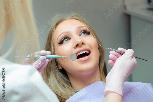 Young woman having medical checkup in the dentist office by the doctor