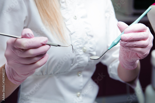 dentist tools in female doctor's hands