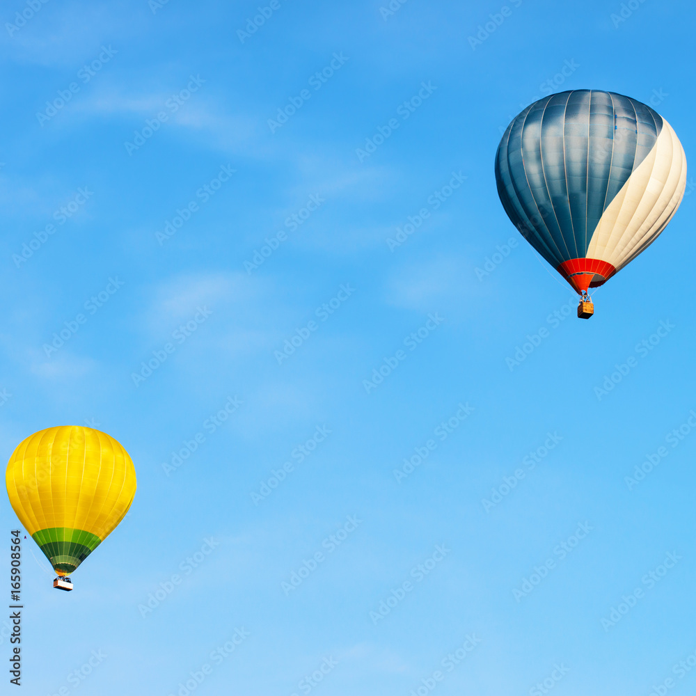 Fototapeta premium Blue and yellow colored hot air balloons in sky Vilnius