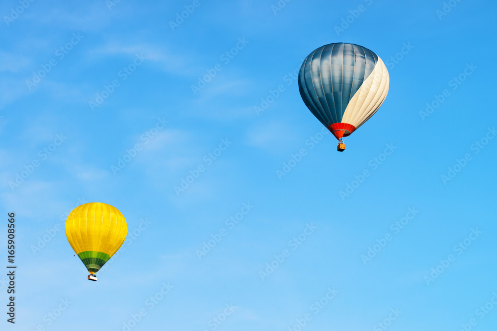 Blue and yellow colored hot air balloons in sky