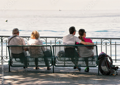 People on bench on embankment Geneva Lake Montreux Swiss Riviera