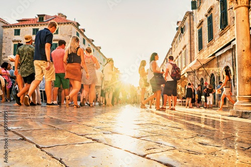 Crowds of tourists at Stradun Street in Dubrovnik at sunset