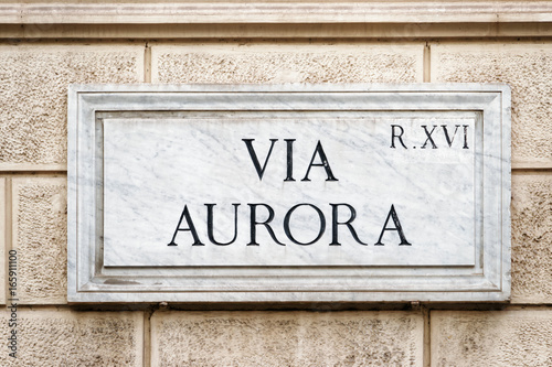 Via Aurora street sign on wall in Rome