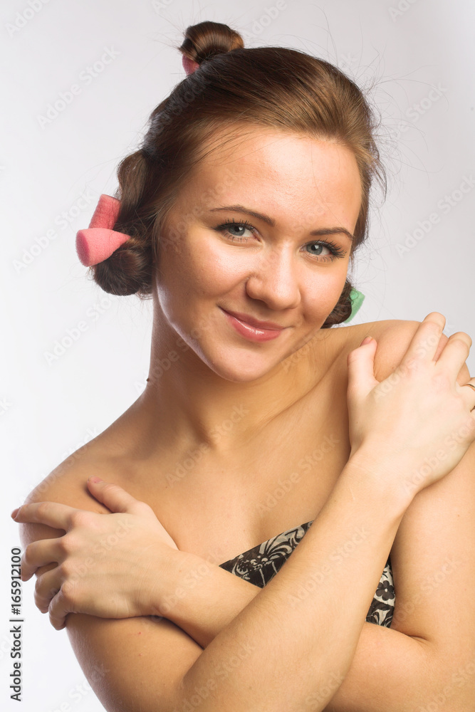 Naklejka premium Beautiful girl with hair curlers