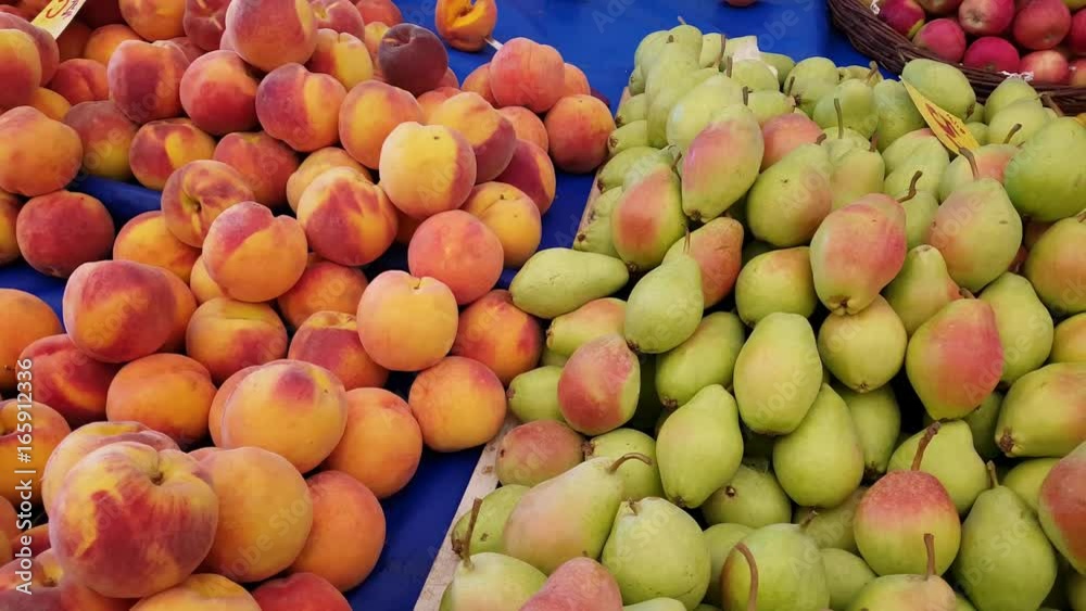 Fresh fruits - peach, pear, apricot - for sale in a market. Fresh fruits - peach, pear, apricot - for sale in a market.