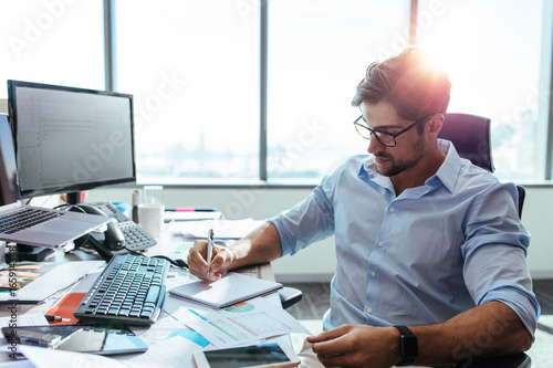 Businessman working at his desk in office. photo