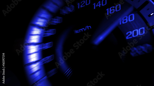 Close up shot of a speed meter in a car with blue light speed at 180 Km/H in concept racing car