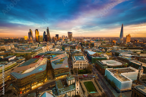 London, England - Panoramic kyline view of the famous financial bank district of London at golden hour. This view includes famous skyscrapers, office buildings and beautiful colorful sky after sunset