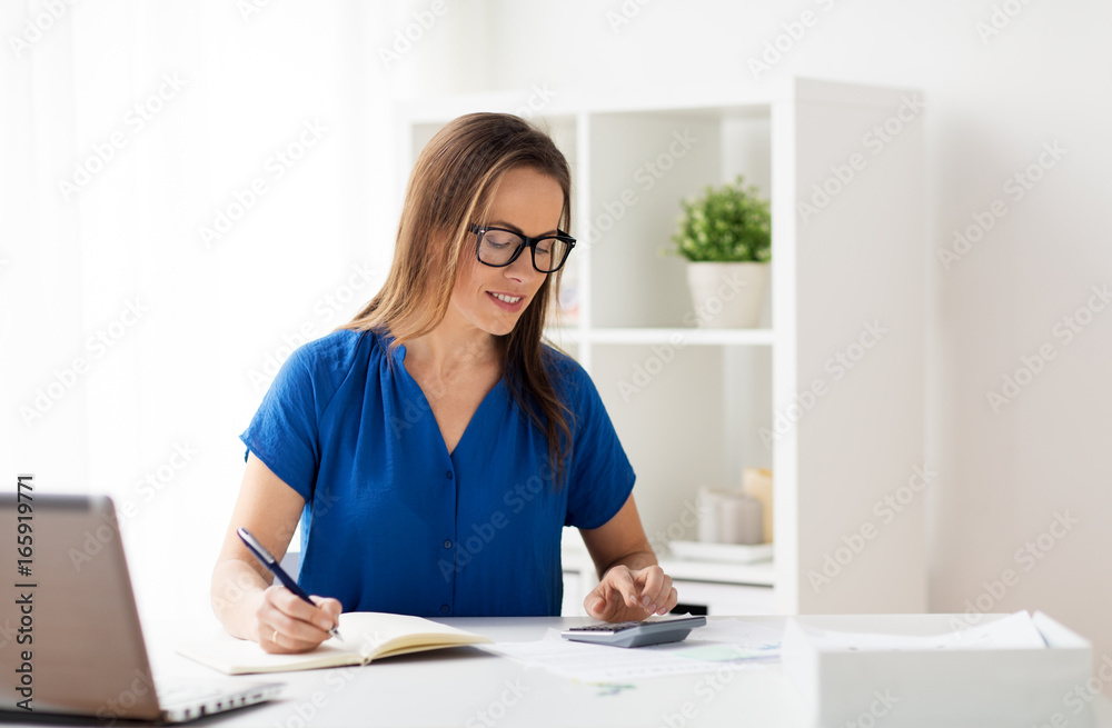 woman with calculator and notebook at office woman with calculator and notebook at office