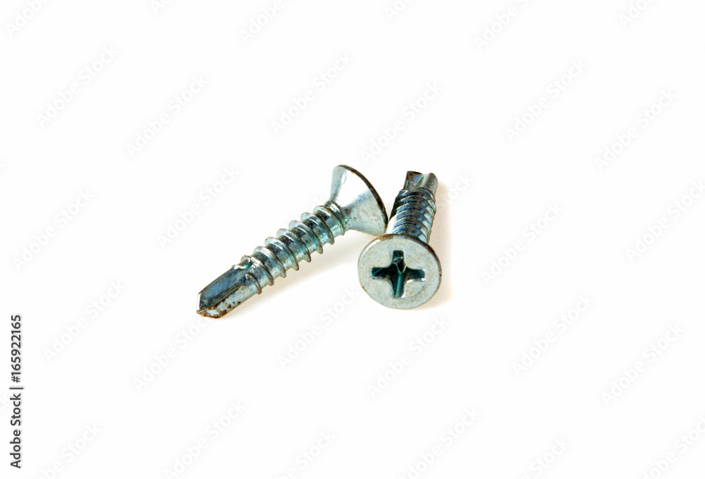 Self-tapping screws on metal on a white background Self-tapping screws on metal on a white background