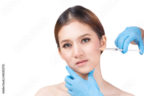 Beauty treatment concept : Female Doctors hands in gloves making an injection in face.