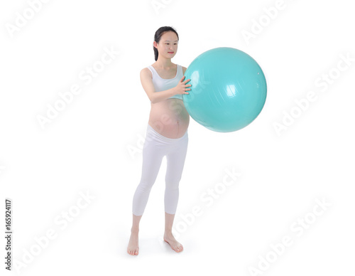 Pregnant woman excercises with gymnastic ball