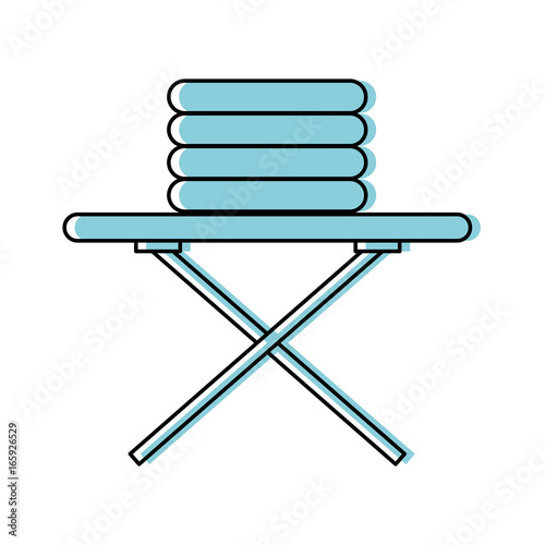 ironing board with pile of clothes