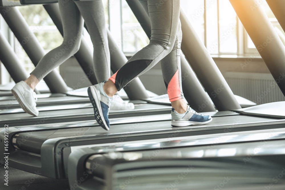 Young women exercise together in the gym Young women exercise together in the gym