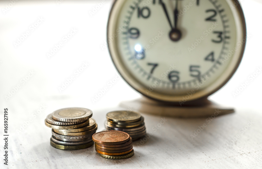 Time is money. Stack of coins with alarm clock for display planning and save money. Financial, business concept