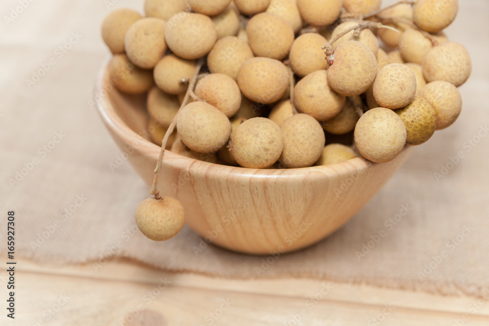 Tropical fruit Longan in wooden bowl Tropical fruit Longan in wooden bowl