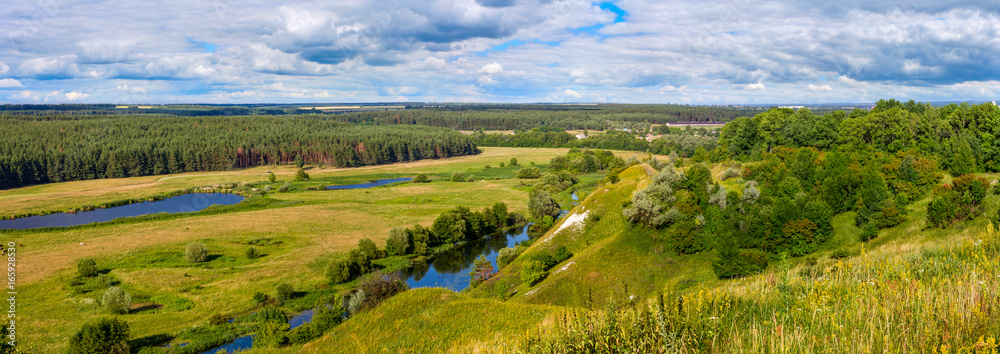 Summertime landscape banner, panorama - river valley of the Siverskyi (Seversky) Donets, the winding river over the meadows between hills and forests, border region of Ukraine near to Russia