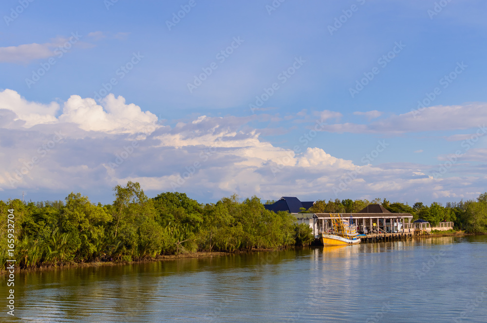 Fototapeta premium Boats at the river near pier of private house on the bank of river