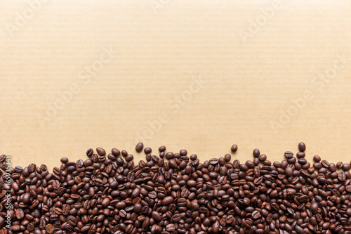coffee bean on paper with soft-focus and over light in the background. top view
