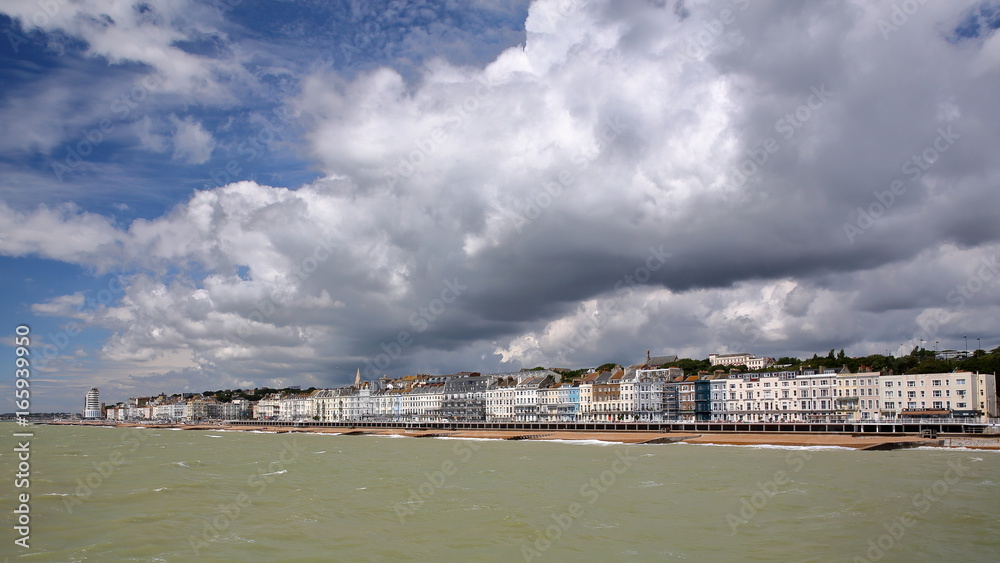 View of the seafront from the Pier with a beautiful cloudy sky, Hastings, UK