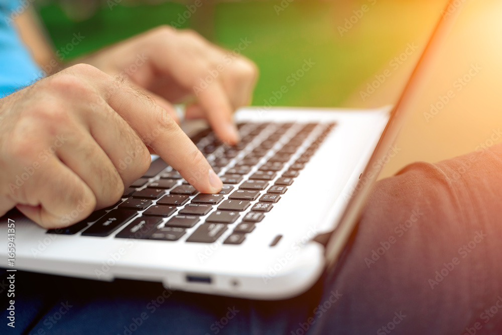 Close-up shot of handsome man's hands touching laptop computer's screen. Close-up shot of handsome man's hands touching laptop computer's screen.