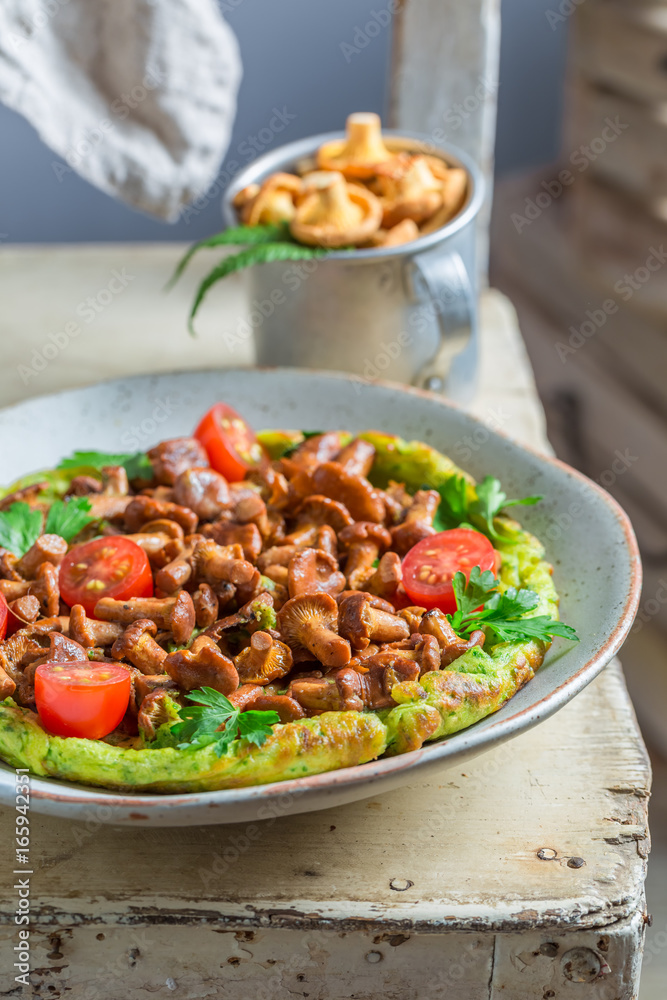 Delicious omelette with mushrooms, cherry tomatoes and parsley