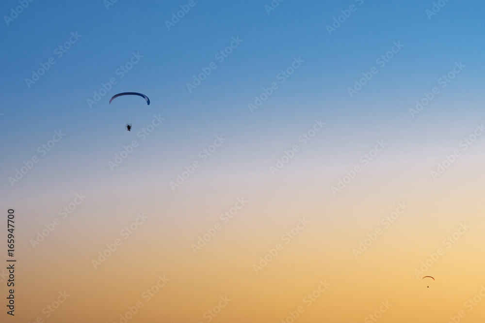 Paraglider in the sky at sunset Paraglider in the sky at sunset