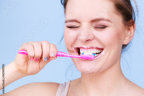 Woman brushing cleaning teeth