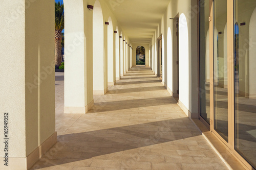 View of the arches of the building in the setting sun. Embankment of Tivat city, Montenegro