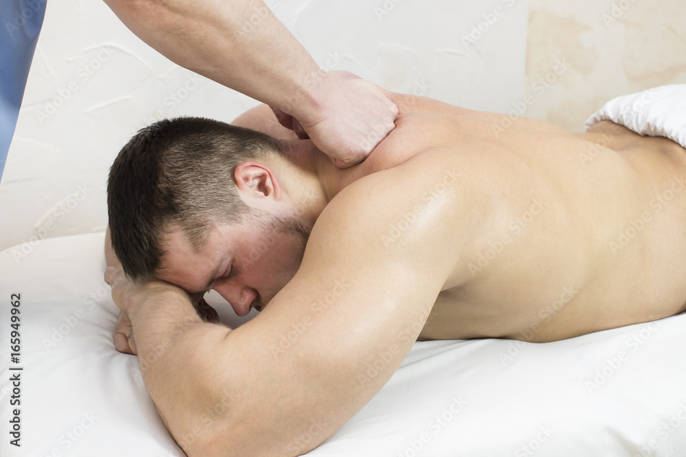 Man doing sports massage at the massage parlor Man doing sports massage at the massage parlor