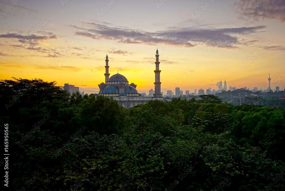 Breathtaking sunrise views with Masjid Wilayah, Kuala Lumpur, Malaysia. Charming Islamic architecture.