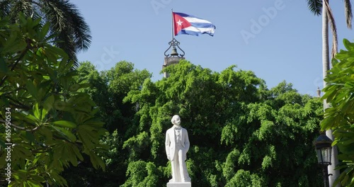 Cuba flag over statue, low angle