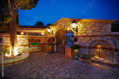 Evening sunset view of entrance small cozy cute boutique hotel on Mediterranean side © Ekaterina