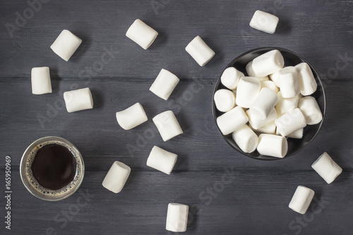 Coffee  with marshmallows on black wood table