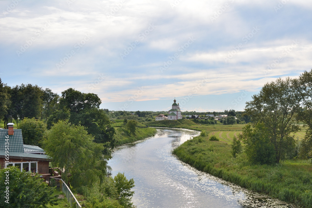 The river called Kamenka in Suzdal in the evening sun The river called Kamenka in Suzdal in the evening sun