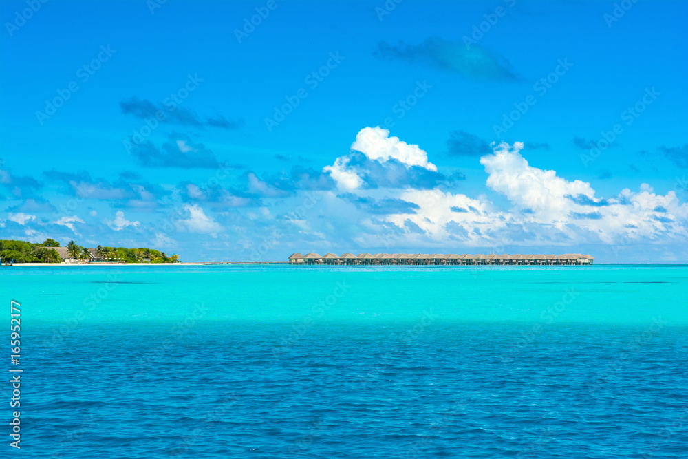 Wooden villas over water on horizont of the Indian Ocean, Maldives Wooden villas over water on horizont of the Indian Ocean, Maldives