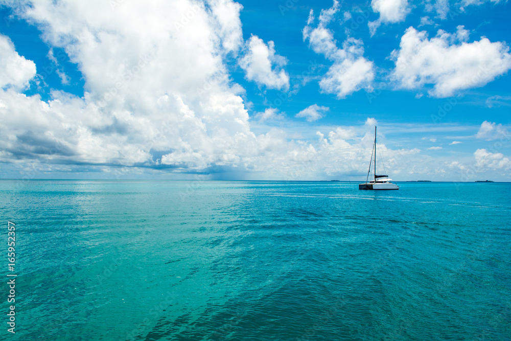 Beautiful landscape with luxury sail catamaran on the clear turquoise water of Indian ocean, Maldives islands Beautiful landscape with luxury sail catamaran on the clear turquoise water of Indian ocean, Maldives islands