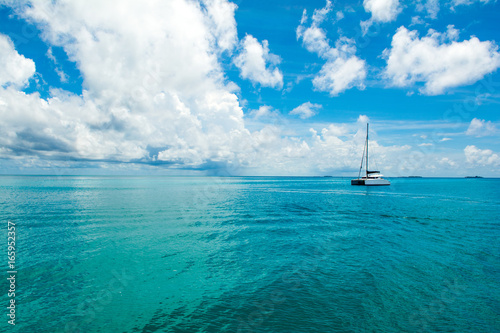 Beautiful landscape with luxury sail catamaran on the clear turquoise water of Indian ocean, Maldives islands
