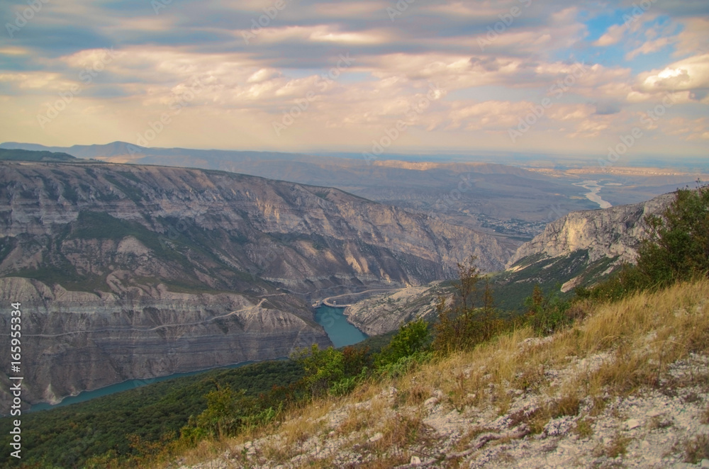 Fototapeta premium Scenic view of the mountains of the Caucasus and valley of the green-blue river in beams of the evening sun. Nature and travel. Russia, Dagestan, Sulaksky Canyon