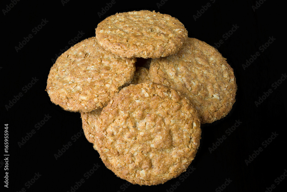 Oatmeal Biscuits on Wooden Board Isolated on Black Oatmeal Biscuits on Wooden Board Isolated on Black