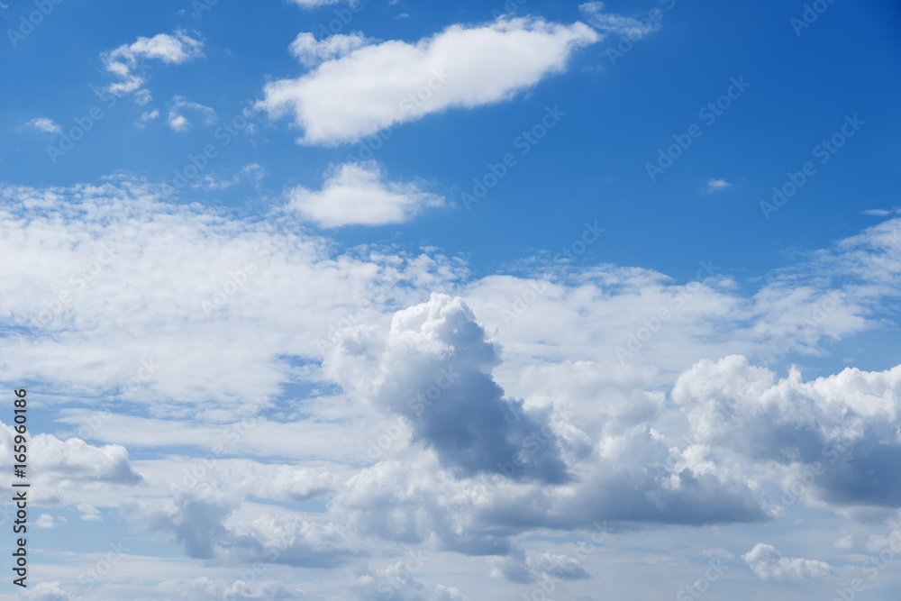 Blue beautiful sky with snow-white clouds of different shapes, background