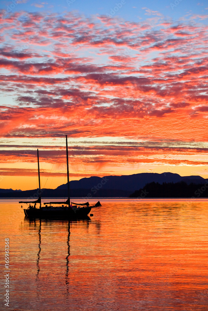 Sailboat at sunset on the west coast of British Columbia 