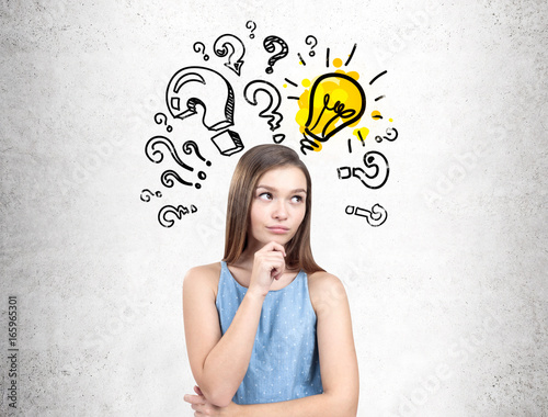 Konstfotografi Pensive teen girl in a dress, questions and a bulb